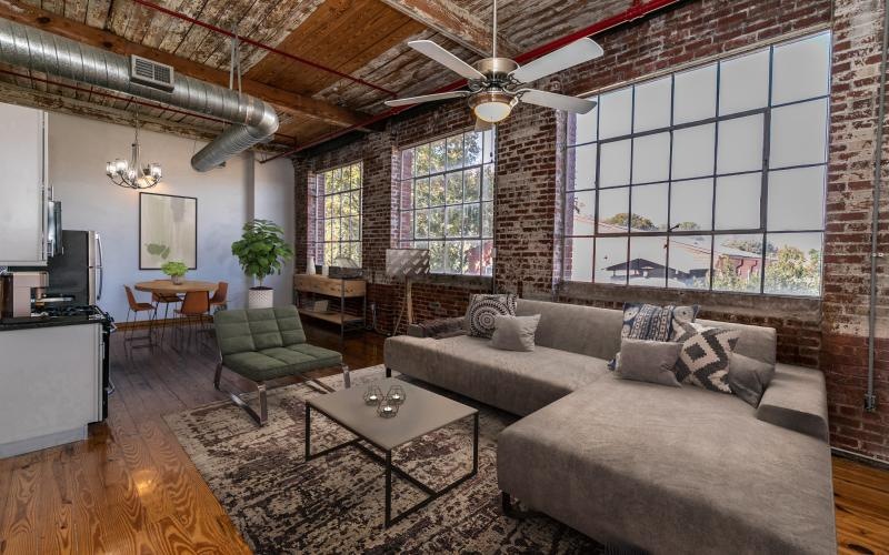 a living room with a brick wall