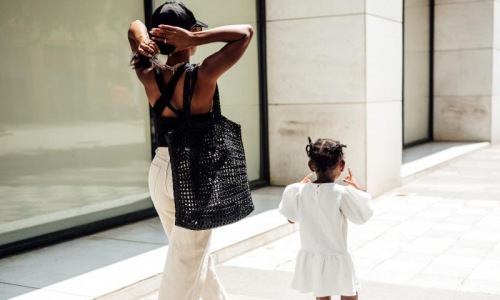 a woman walking with her child